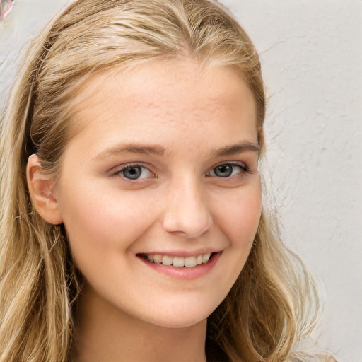 Joyful white child female with long  brown hair and blue eyes