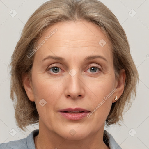 Joyful white adult female with medium  brown hair and grey eyes