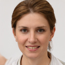 Joyful white young-adult female with medium  brown hair and grey eyes