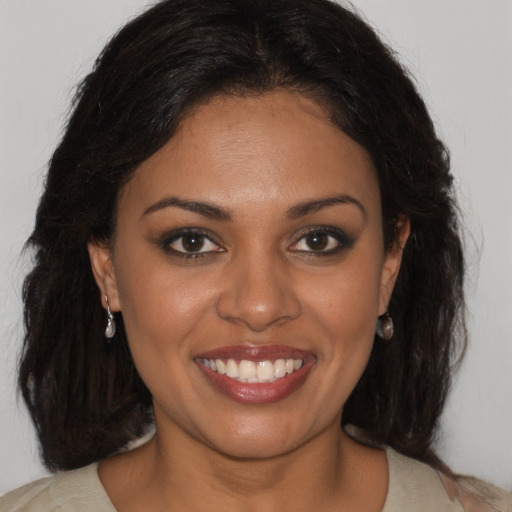 Joyful black young-adult female with medium  brown hair and brown eyes