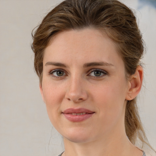 Joyful white young-adult female with medium  brown hair and grey eyes