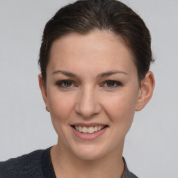 Joyful white young-adult female with short  brown hair and grey eyes