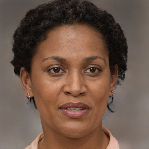 Joyful black adult female with short  brown hair and brown eyes