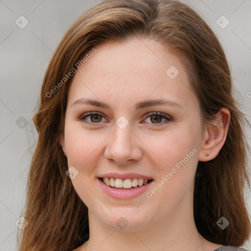 Joyful white young-adult female with long  brown hair and green eyes