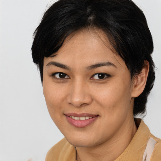 Joyful asian young-adult female with short  brown hair and brown eyes