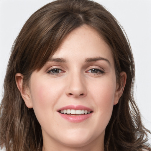 Joyful white young-adult female with long  brown hair and grey eyes