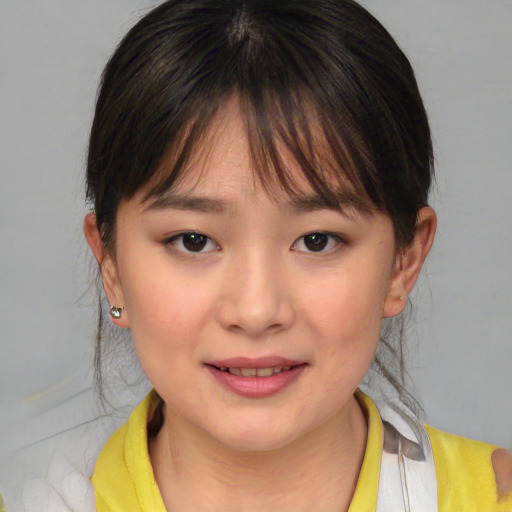 Joyful asian child female with medium  brown hair and brown eyes