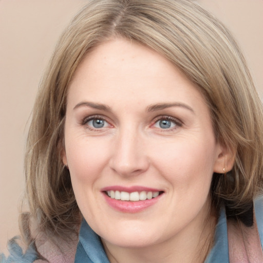 Joyful white young-adult female with medium  brown hair and blue eyes