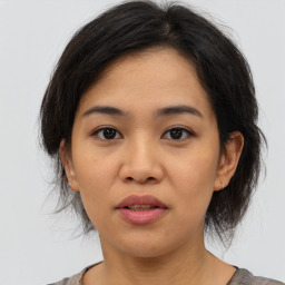 Joyful asian young-adult female with medium  brown hair and brown eyes