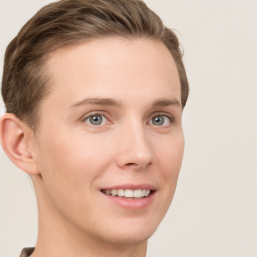 Joyful white young-adult female with short  brown hair and grey eyes