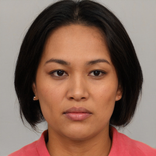Neutral asian young-adult female with medium  brown hair and brown eyes