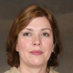 Joyful white adult female with medium  brown hair and brown eyes