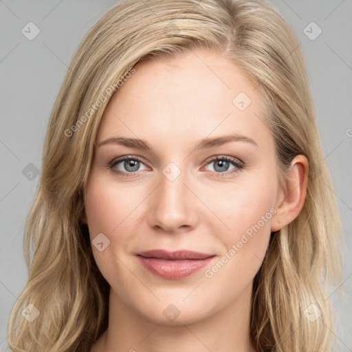 Joyful white young-adult female with long  brown hair and blue eyes