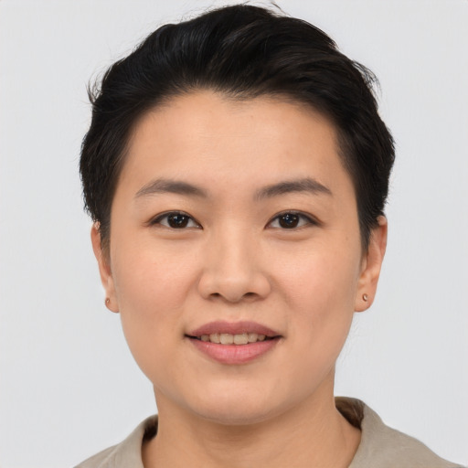 Joyful asian young-adult female with short  brown hair and brown eyes
