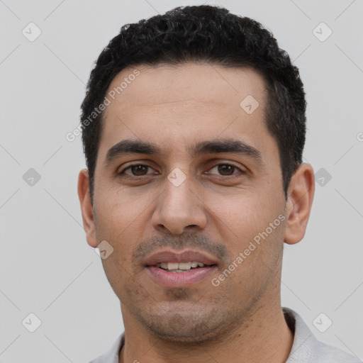 Joyful latino young-adult male with short  black hair and brown eyes