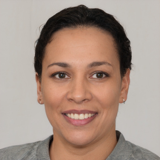 Joyful white young-adult female with short  black hair and brown eyes