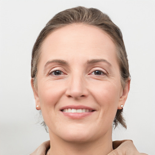 Joyful white adult female with medium  brown hair and grey eyes