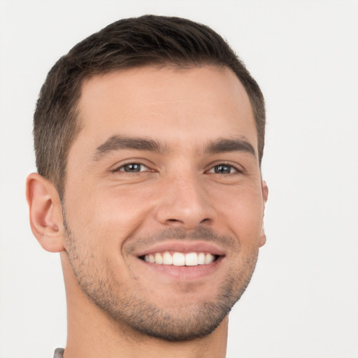 Joyful white young-adult male with short  brown hair and brown eyes