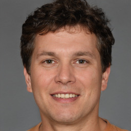 Joyful white adult male with short  brown hair and brown eyes