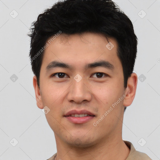 Joyful asian young-adult male with short  black hair and brown eyes