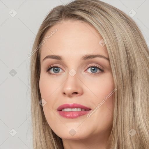 Joyful white young-adult female with long  brown hair and blue eyes