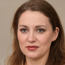 Joyful white young-adult female with long  brown hair and grey eyes