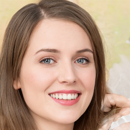 Joyful white young-adult female with long  brown hair and green eyes