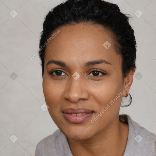 Joyful black young-adult female with short  black hair and brown eyes