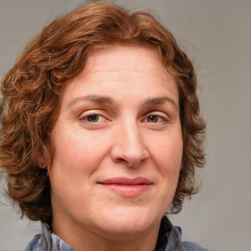 Joyful white adult female with medium  brown hair and blue eyes