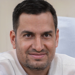 Joyful white adult male with short  brown hair and brown eyes