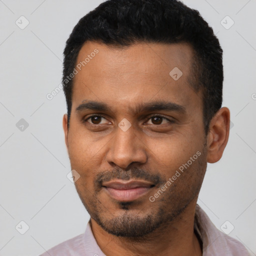 Joyful black young-adult male with short  black hair and brown eyes