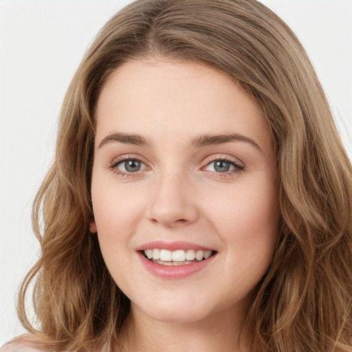 Joyful white young-adult female with long  brown hair and green eyes