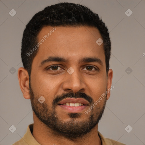 Joyful black young-adult male with short  black hair and brown eyes