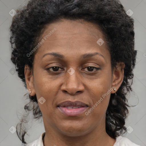 Joyful black adult female with medium  brown hair and brown eyes