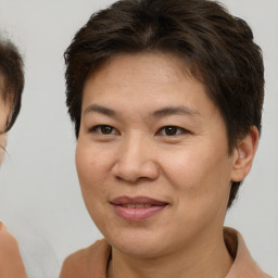 Joyful white adult female with short  brown hair and brown eyes