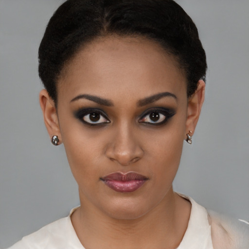 Joyful black young-adult female with short  brown hair and brown eyes