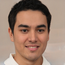 Joyful latino young-adult male with short  brown hair and brown eyes