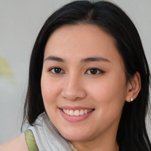 Joyful asian young-adult female with medium  brown hair and brown eyes