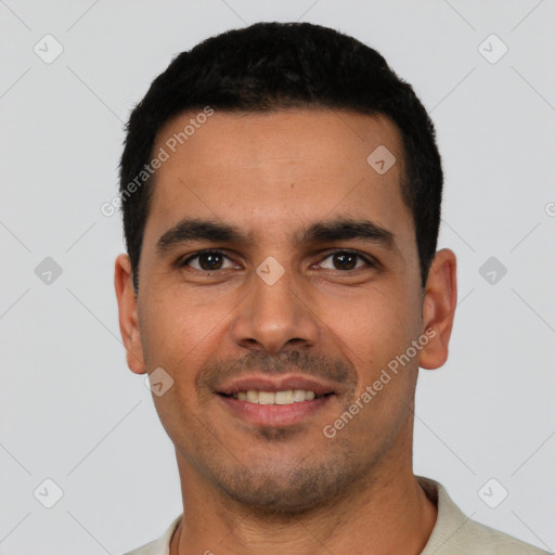 Joyful latino young-adult male with short  black hair and brown eyes