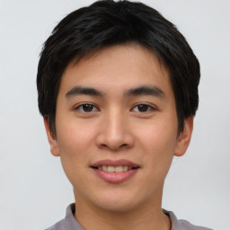 Joyful asian young-adult male with short  black hair and brown eyes