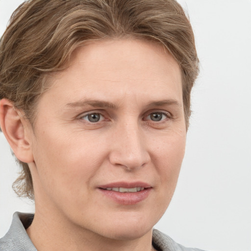 Joyful white adult female with short  brown hair and grey eyes