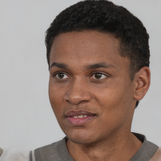 Joyful black young-adult male with short  black hair and brown eyes