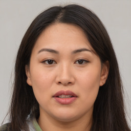 Joyful white adult female with long  brown hair and brown eyes