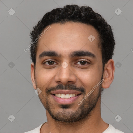 Joyful latino young-adult male with short  black hair and brown eyes