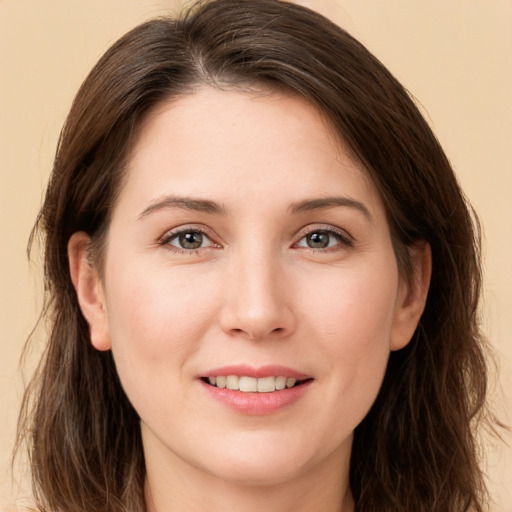 Joyful white young-adult female with long  brown hair and brown eyes