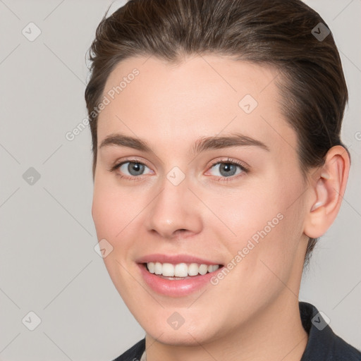 Joyful white young-adult female with medium  brown hair and grey eyes