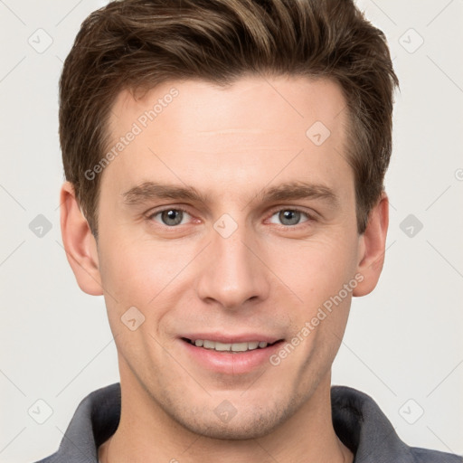 Joyful white young-adult male with short  brown hair and grey eyes