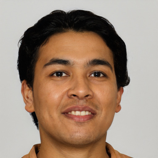 Joyful latino young-adult male with short  black hair and brown eyes