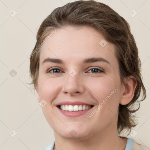 Joyful white young-adult female with medium  brown hair and grey eyes