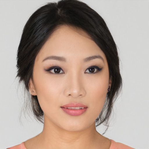 Joyful asian young-adult female with medium  black hair and brown eyes